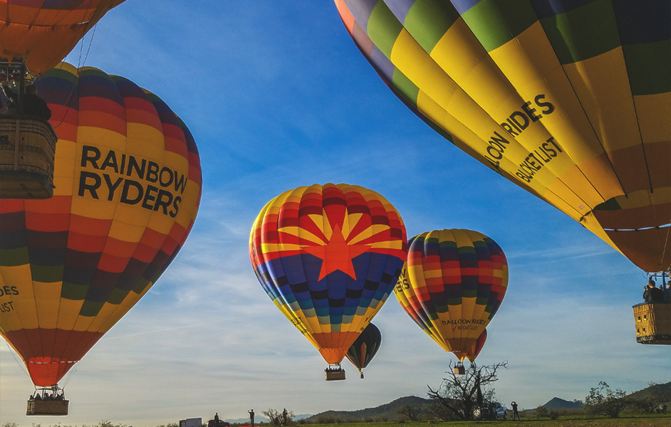 A colorful hot air balloon floating above a scenic landscape