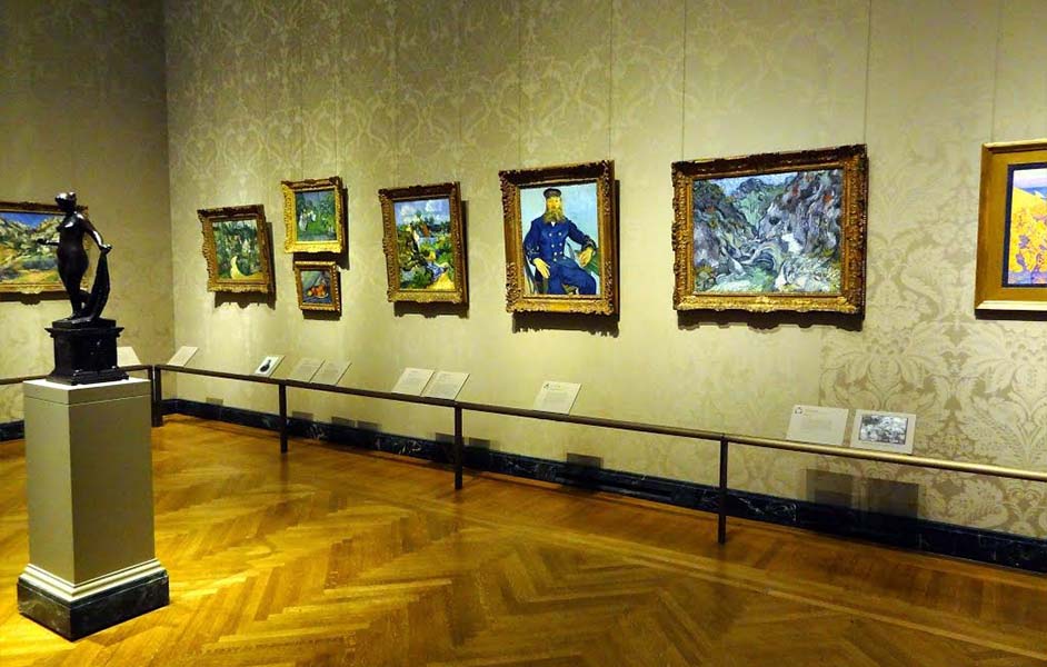 Visitors viewing Van Gogh paintings in exhibition hall