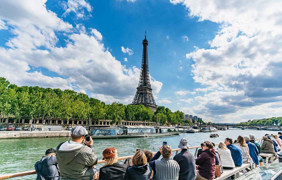 Family enjoying a Seine River boat cruise with views of Paris landmarks