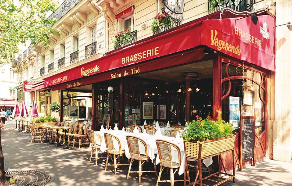 Parisian café with outdoor seating and visitors enjoying spring weather in May