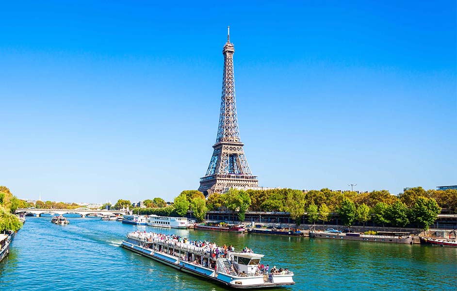 Seine River cruise with visitors and clear skies in Paris during May